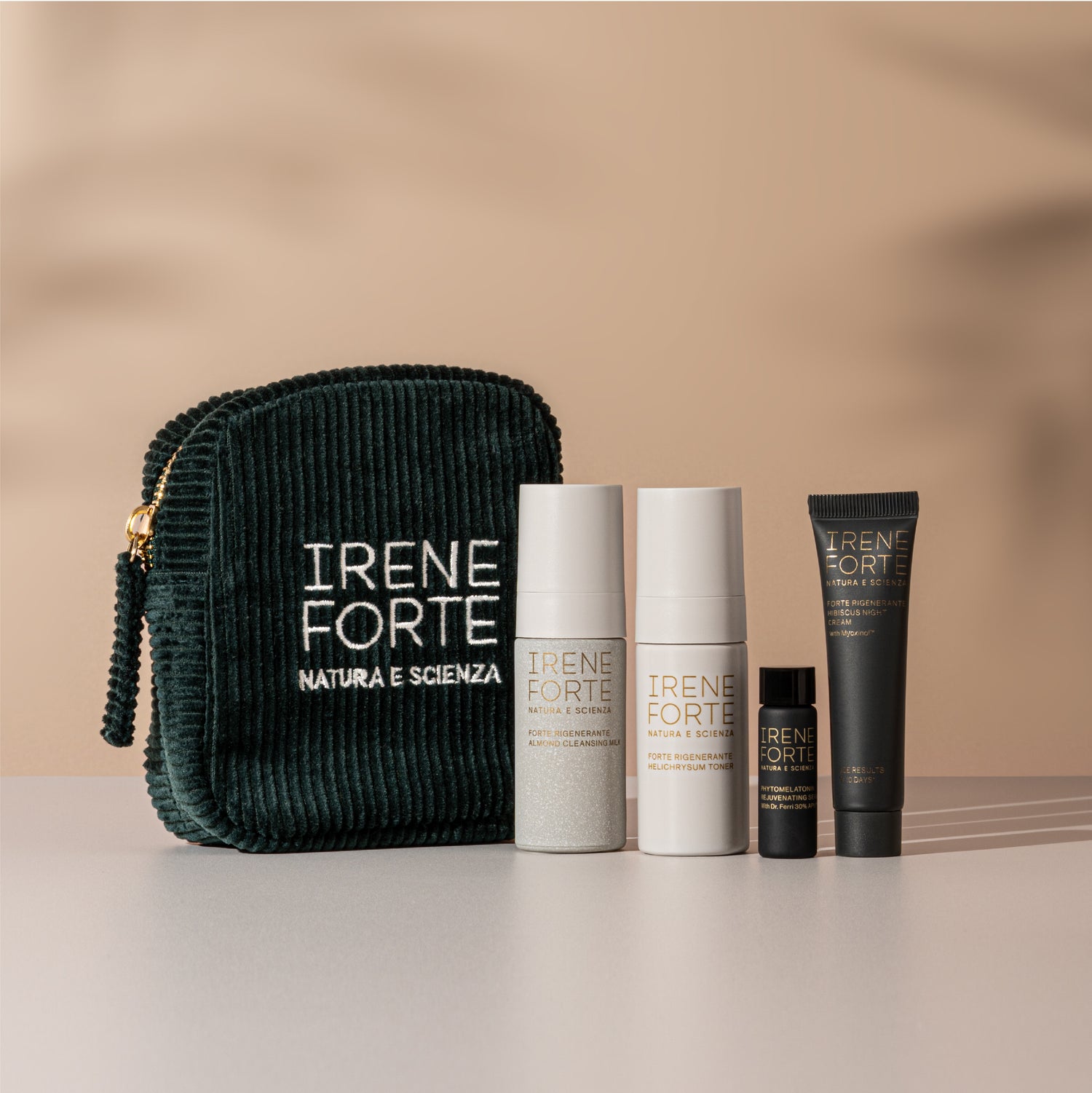 Irene Forte skincare products including a dark green pouch and various bottles on a beige background